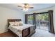 Spacious bedroom with a wooden bed frame and sliding glass doors leading to a balcony at 1905 E Mulberry Dr # 2, Tampa, FL 33604
