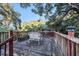 Wooden deck overlooking lush trees and a tranquil setting at 1905 E Mulberry Dr # 1, Tampa, FL 33604