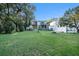 Large backyard with lush grass and mature trees at 1905 E Mulberry Dr # 1, Tampa, FL 33604