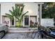 Modern building exterior with lush tropical landscaping and electric vehicle charging station at 1905 E Mulberry Dr # 1, Tampa, FL 33604