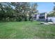 Spacious backyard with a two-story house and lush landscaping at 1905 E Mulberry Dr # 1, Tampa, FL 33604