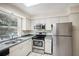 Kitchen with stainless steel appliances and window at 7585 Abonado Rd, Tampa, FL 33615