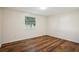 Spacious bedroom with wood flooring and a window at 7585 Abonado Rd, Tampa, FL 33615