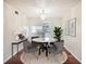 Bright dining room with round table and four chairs, hardwood floors and chandelier at 7585 Abonado Rd, Tampa, FL 33615