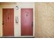 Building entrance with two red doors and wall at 7585 Abonado Rd, Tampa, FL 33615