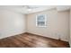 Bright bedroom with wood-look floors and a window at 7585 Abonado Rd, Tampa, FL 33615