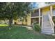 Building exterior with stairs and lush lawn at 7585 Abonado Rd, Tampa, FL 33615