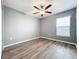 Bedroom with wood-look floors and a ceiling fan at 10229 Summer Kiss Ave, Riverview, FL 33578