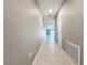 Long hallway with tile floors and gray walls at 10229 Summer Kiss Ave, Riverview, FL 33578