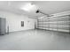 Garage with epoxy floor, water heater, and automatic opener at 10229 Summer Kiss Ave, Riverview, FL 33578