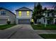 Two-story house with gray siding, gray garage door, and a well-manicured lawn at 12716 Hampton Hill Dr, Riverview, FL 33578