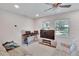 Bright living room featuring a comfy sofa, large TV, and ceiling fan at 1404 E Frances Ave, Plant City, FL 33563