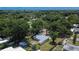 Aerial view of single story home with large backyard, surrounded by lush trees at 1404 E Frances Ave, Plant City, FL 33563
