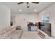 Bright living room featuring a comfy sofa, large TV, and ceiling fan at 1404 E Frances Ave, Plant City, FL 33563