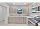 Modern kitchen features stainless steel appliances and light beige cabinets at 1404 E Frances Ave, Plant City, FL 33563