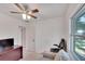 Bedroom with couch, office chair and ceiling fan at 1404 E Frances Ave, Plant City, FL 33563