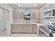 Modern kitchen features stainless steel appliances and light beige cabinets at 1404 E Frances Ave, Plant City, FL 33563
