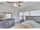 Bright bedroom with wood-like dresser and ceiling fan at 1404 E Frances Ave, Plant City, FL 33563