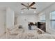Bright living room featuring a comfy sofa, large TV, and ceiling fan at 1404 E Frances Ave, Plant City, FL 33563
