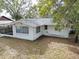 Back view of home with covered porch and spacious backyard at 5824 11Th St, Zephyrhills, FL 33542