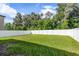 Large fenced backyard with grassy area at 6267 Back Forty Loop, Zephyrhills, FL 33541