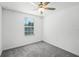 Simple bedroom with ceiling fan and grey carpet at 6267 Back Forty Loop, Zephyrhills, FL 33541