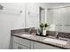 Double vanity bathroom with granite countertop and modern fixtures at 6267 Back Forty Loop, Zephyrhills, FL 33541