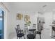 Dining area with glass table and four black chairs at 6267 Back Forty Loop, Zephyrhills, FL 33541