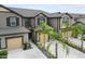 Two-story townhome with tan siding, brown accents, and attached garage at 11826 Sky Acres Ter, Bradenton, FL 34211