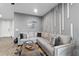 Living room with gray sectional sofa and accent wall at 11826 Sky Acres Ter, Bradenton, FL 34211