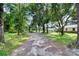 Long driveway leading to a house nestled in trees at 7249 Berry Rd, Zephyrhills, FL 33540