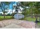 Backyard patio with a shed and chain link fence at 7249 Berry Rd, Zephyrhills, FL 33540