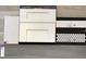 New Haven kitchen design; white cabinets, quartz countertops, and penny round tile at 16227 Alpha Grove Pl, Odessa, FL 33556