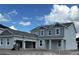 Two-story home with gray siding, large windows, and attached two-car garage at 16227 Alpha Grove Pl, Odessa, FL 33556