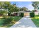 Brick ranch home with a carport and well-manicured lawn at 5824 11Th St, Zephyrhills, FL 33542