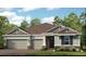 Two-story home with three-car garage and landscaping at 16224 Alpha Grove Pl, Odessa, FL 33556