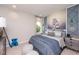 Serene bedroom with a stunning mountain mural and plenty of light at 11209 Manor House Ln, Odessa, FL 33556