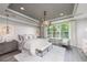 Luxurious main bedroom with plush bedding and a stunning chandelier at 11209 Manor House Ln, Odessa, FL 33556