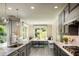 Modern kitchen with gray cabinetry, quartz countertops, and breakfast nook at 11209 Manor House Ln, Odessa, FL 33556