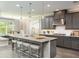 Modern kitchen with gray cabinets and large island at 11209 Manor House Ln, Odessa, FL 33556