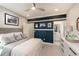 Bright bedroom with navy feature wall and ensuite bathroom at 11209 Manor House Ln, Odessa, FL 33556
