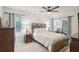 Main bedroom with a king-size bed and ceiling fan at 1681 Macdonnell Ct, Palm Harbor, FL 34684