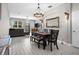 Open concept dining room with a farmhouse table and chandelier at 1932 Lake Waters Pl, Lutz, FL 33558