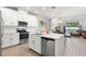 Modern kitchen with white shaker cabinets, a large island, and stainless steel appliances at 8731 Terracina Lake Dr, Tampa, FL 33625