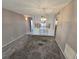 Spacious living room with grey carpet and chandelier at 6322 Palma Del Mar S Blvd # 215, St Petersburg, FL 33715