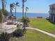 Stunning waterfront view with patio furniture and lush landscaping at 6322 Palma Del Mar S Blvd # 215, St Petersburg, FL 33715