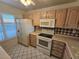 Kitchen features white appliances and wood cabinets at 6322 Palma Del Mar S Blvd # 215, St Petersburg, FL 33715