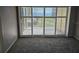 Bedroom with carpet flooring and sliding glass doors to balcony with water views at 6322 Palma Del Mar S Blvd # 215, St Petersburg, FL 33715