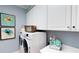Bright laundry room with washer, dryer, and ample storage at 11172 Manor House Ln, Odessa, FL 33556