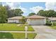 Single-story home with attached garage and well-kept lawn at 1681 Macdonnell Ct, Palm Harbor, FL 34684